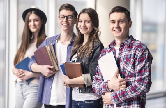 Group of happy young students in a university.